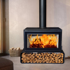 Wood-burning stove with flames and stacked logs in a room setting