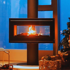 Modern fireplace with flames in a room with a blue wall and decorative items.