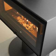 Modern fireplace with glowing coals inside a glass enclosure.